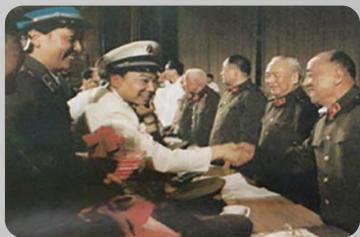 Historical photo of a formal meeting with military personnel in uniform shaking hands (no visible text or symbols)